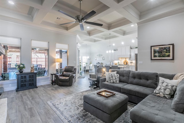 living area with visible vents, beamed ceiling, and a healthy amount of sunlight