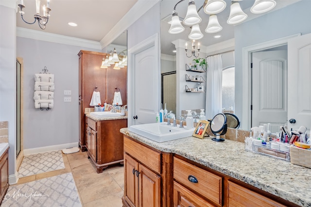 bathroom featuring crown molding, a notable chandelier, a shower stall, and a sink