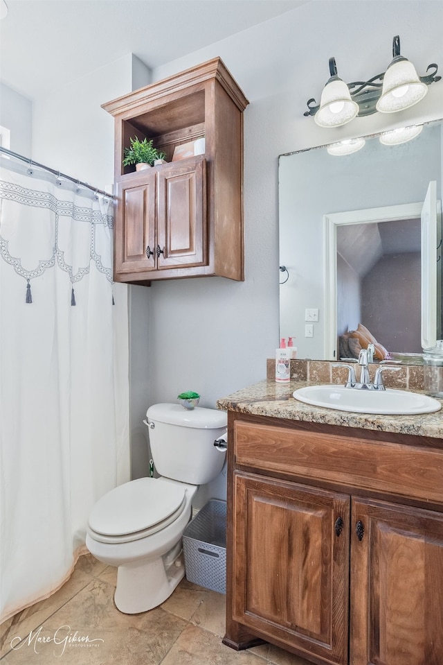 bathroom featuring vanity, a shower with shower curtain, and toilet