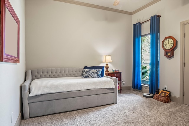 carpeted bedroom featuring ceiling fan, baseboards, and ornamental molding