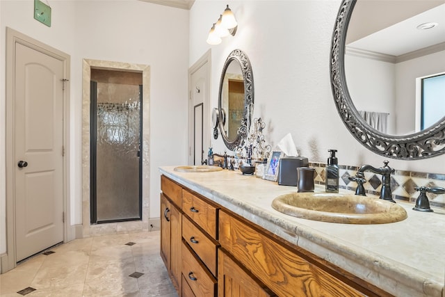 full bathroom featuring a sink, double vanity, ornamental molding, and a shower stall