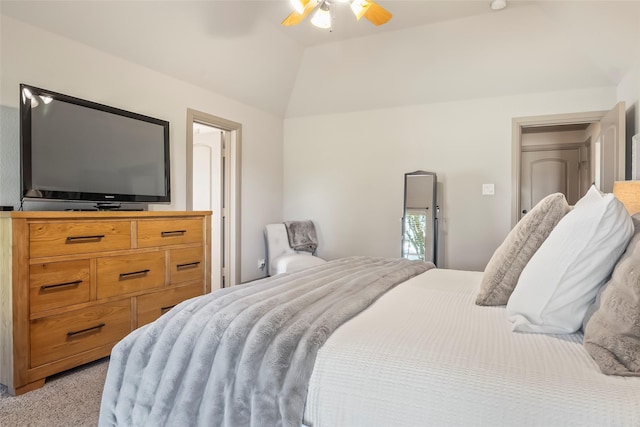 bedroom featuring lofted ceiling, light carpet, and a ceiling fan