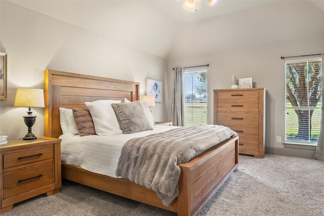 bedroom with lofted ceiling and light carpet