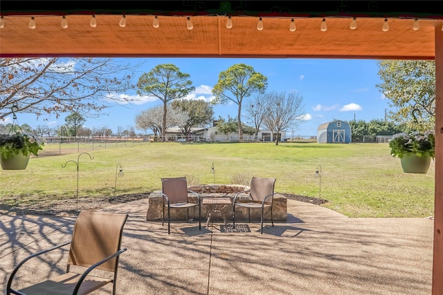 view of patio featuring fence, an outdoor structure, and a shed