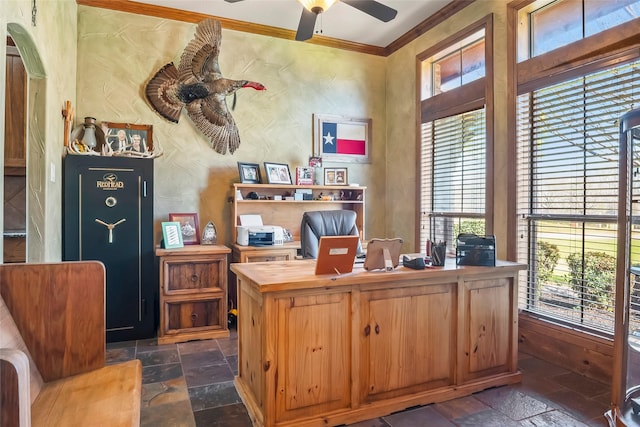 office area with stone tile flooring, arched walkways, ceiling fan, and ornamental molding