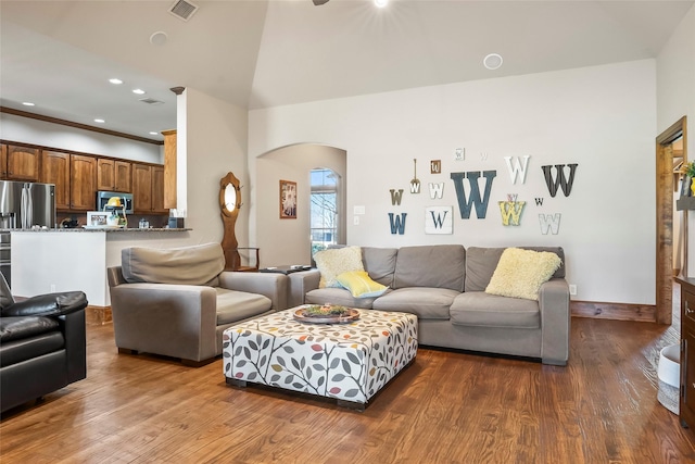 living area with visible vents, dark wood finished floors, recessed lighting, arched walkways, and high vaulted ceiling