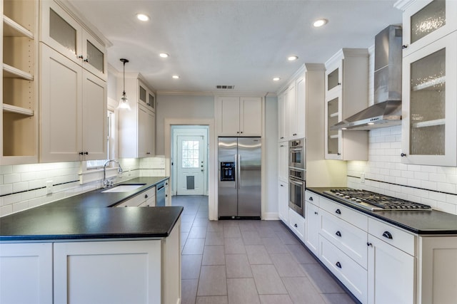 kitchen featuring visible vents, dark countertops, appliances with stainless steel finishes, and wall chimney exhaust hood