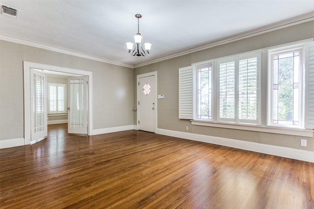 entrance foyer with crown molding, a notable chandelier, visible vents, and dark wood-style flooring