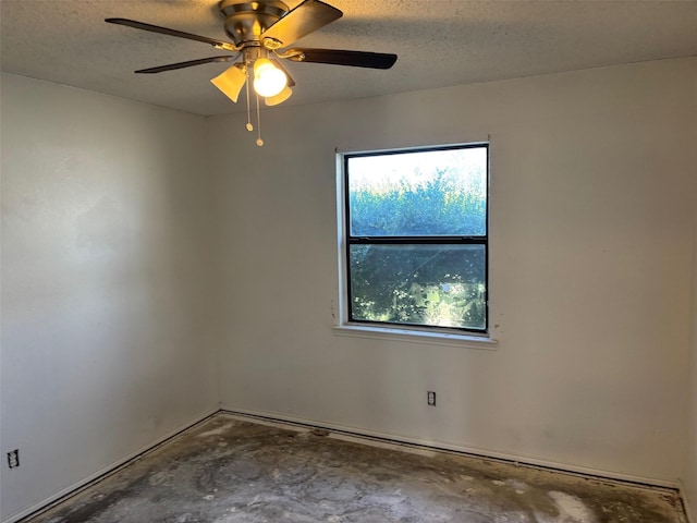 unfurnished room with a textured ceiling, concrete floors, and a healthy amount of sunlight