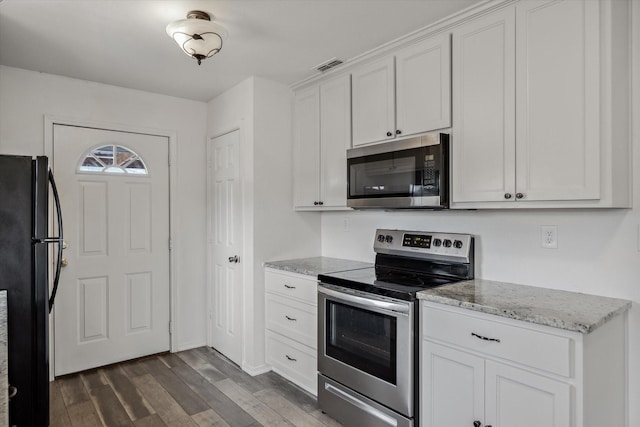 kitchen featuring light stone countertops, visible vents, dark wood-type flooring, appliances with stainless steel finishes, and white cabinetry