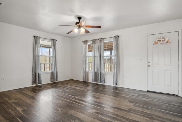 interior space with a ceiling fan, wood finished floors, and baseboards