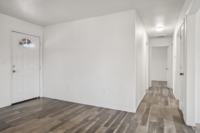 entryway with visible vents, baseboards, and dark wood finished floors