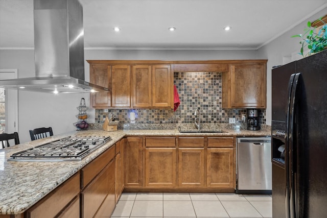 kitchen featuring brown cabinets, ornamental molding, island exhaust hood, a sink, and appliances with stainless steel finishes