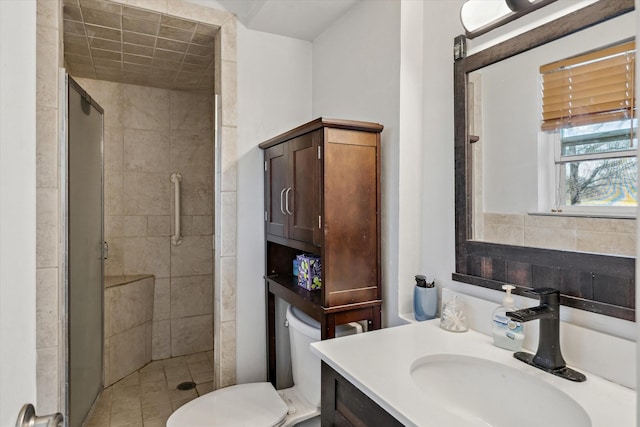 full bathroom with vanity, toilet, and a stall shower