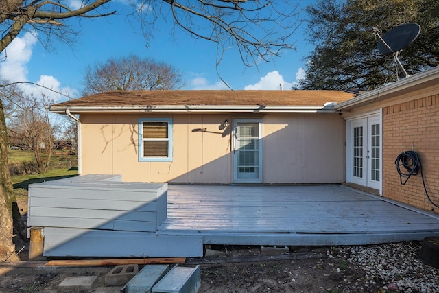 back of property with french doors, brick siding, and a wooden deck