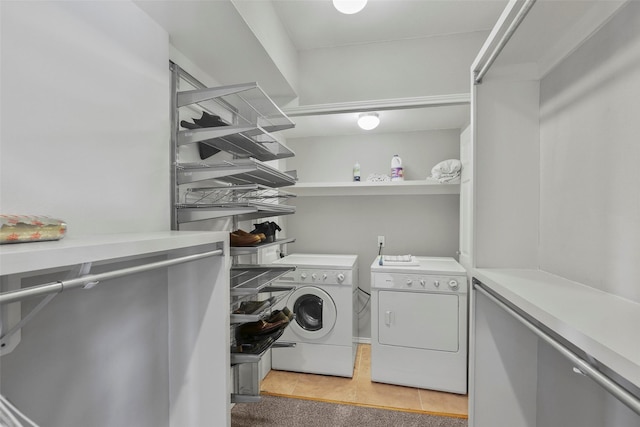 laundry room featuring laundry area, light tile patterned floors, and washing machine and dryer