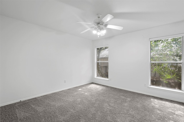 spare room with baseboards, carpet floors, and a ceiling fan