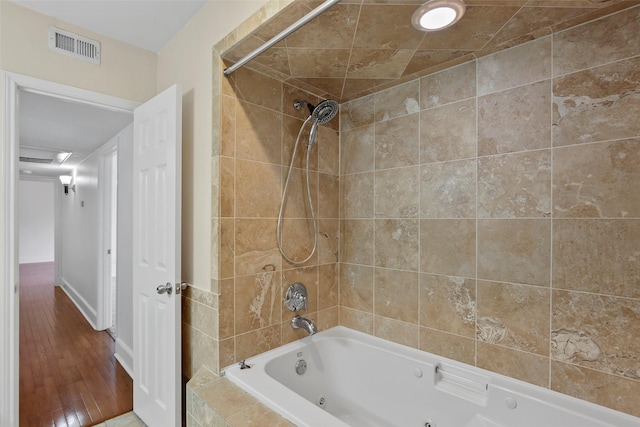 bathroom featuring visible vents and a combined bath / shower with jetted tub