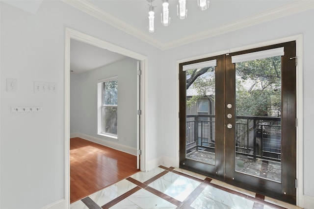 entrance foyer featuring french doors, baseboards, plenty of natural light, and crown molding