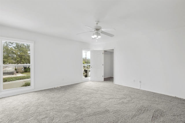 unfurnished room with baseboards, carpet, and a ceiling fan