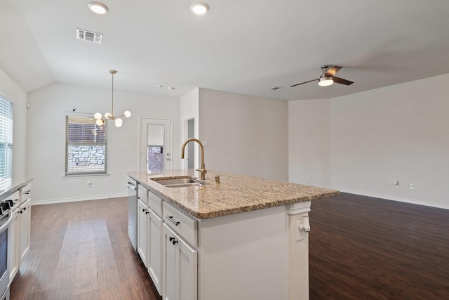 kitchen with light stone counters, visible vents, a sink, dark wood-type flooring, and white cabinets