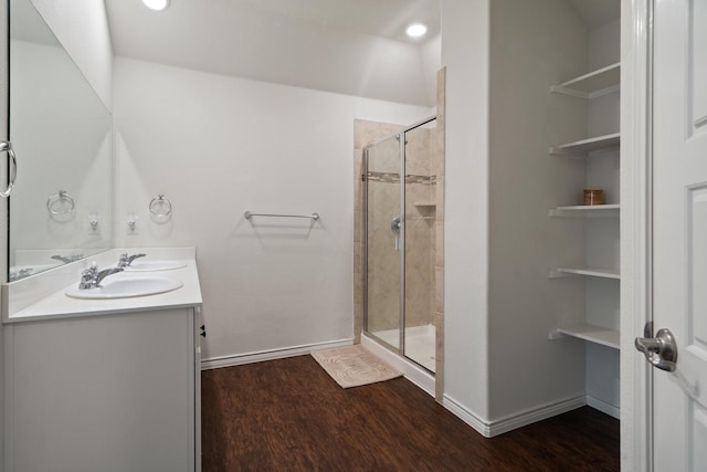 full bath featuring wood finished floors, a stall shower, and a sink