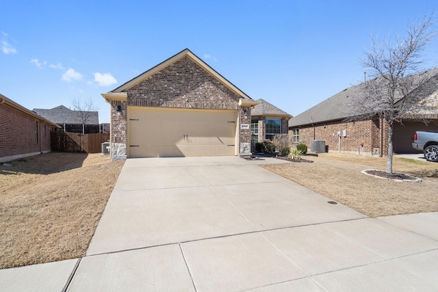 view of property exterior with central AC, fence, concrete driveway, an attached garage, and brick siding