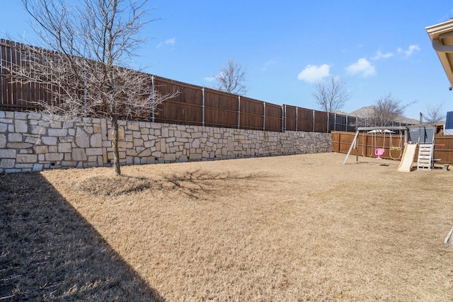 view of yard featuring a playground and a fenced backyard