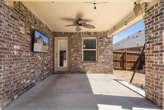 view of patio / terrace with a ceiling fan and fence