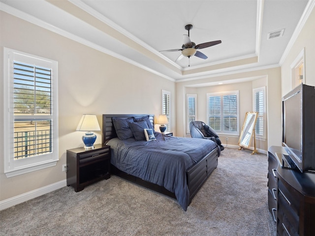 bedroom with visible vents, baseboards, crown molding, a raised ceiling, and carpet flooring