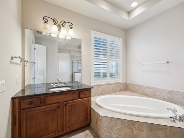 full bathroom with vanity, a shower stall, and a bath