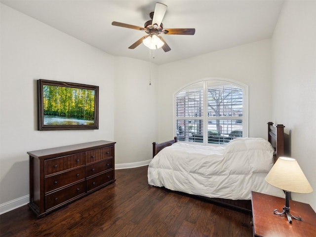 bedroom with ceiling fan, baseboards, and wood finished floors