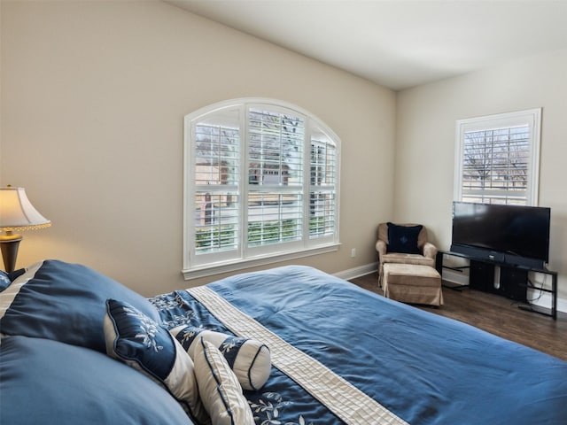 bedroom featuring baseboards and wood finished floors