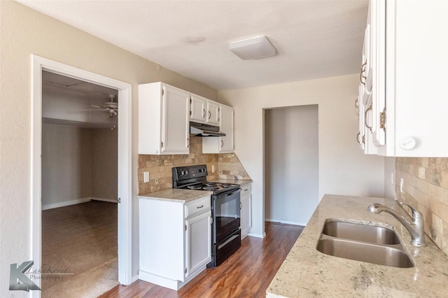 kitchen featuring wood finished floors, a sink, white cabinets, black range with electric cooktop, and under cabinet range hood