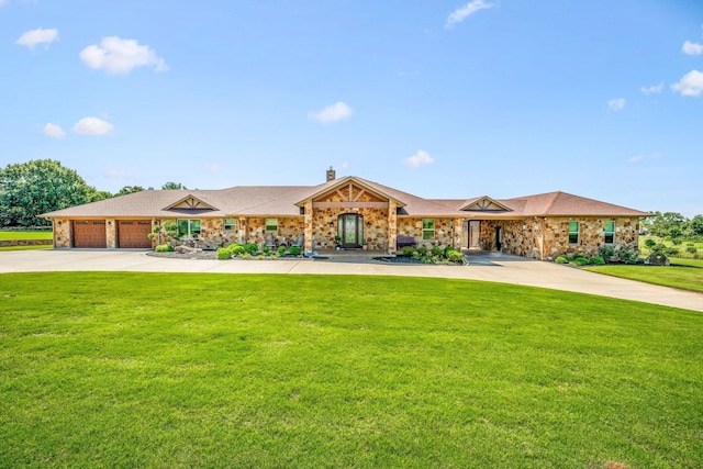 view of front of house featuring a front yard, concrete driveway, brick siding, and a chimney