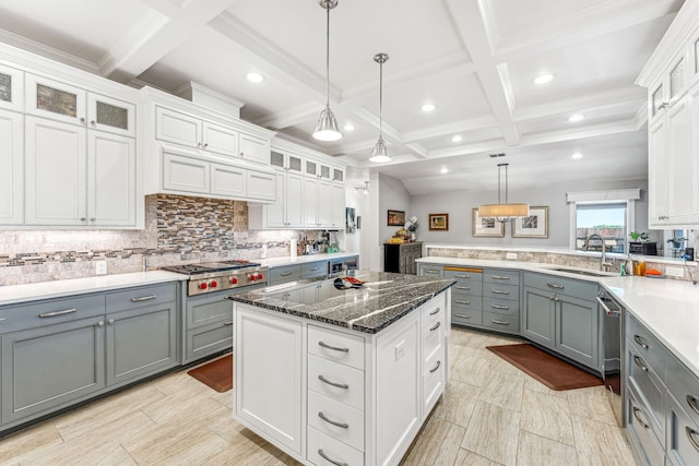 kitchen featuring backsplash, gray cabinets, white cabinets, stainless steel appliances, and a sink