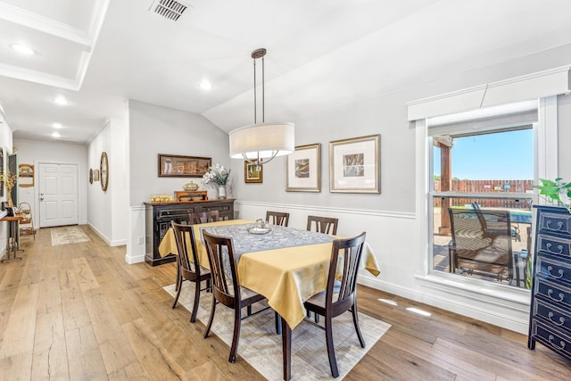 dining space with baseboards, visible vents, light wood finished floors, and ornamental molding