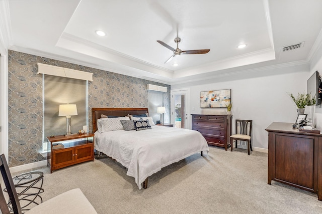 bedroom with wallpapered walls, a raised ceiling, visible vents, and light carpet