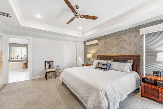 bedroom with visible vents, baseboards, carpet flooring, crown molding, and a raised ceiling