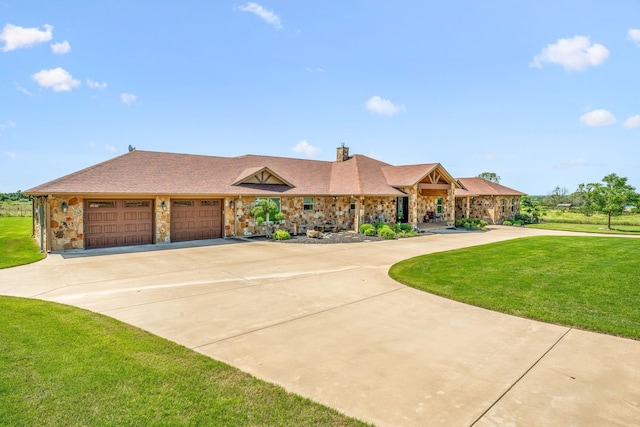 view of front of property with stone siding, a front lawn, and driveway