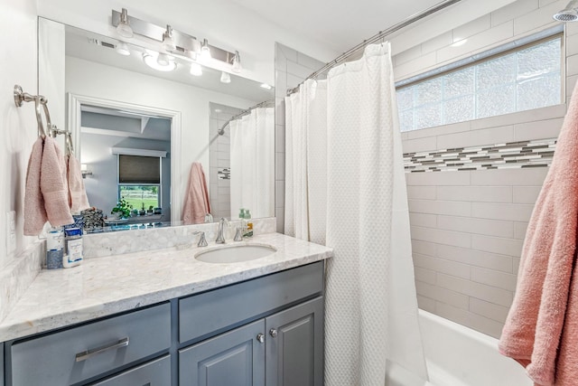 bathroom featuring vanity and shower / bath combo