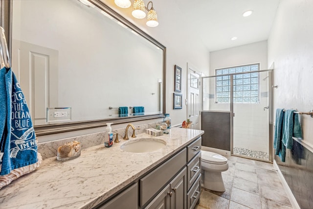 bathroom featuring vanity, a shower stall, toilet, and recessed lighting