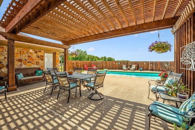 view of patio / terrace with a pergola, outdoor dining area, a fenced backyard, and a fenced in pool