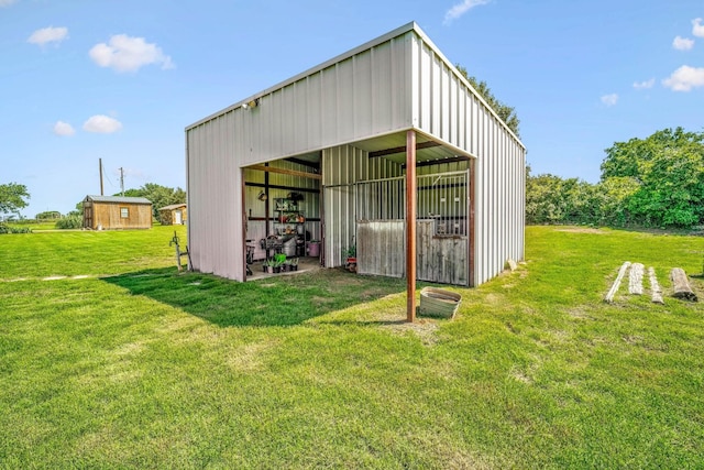 view of pole building with a yard