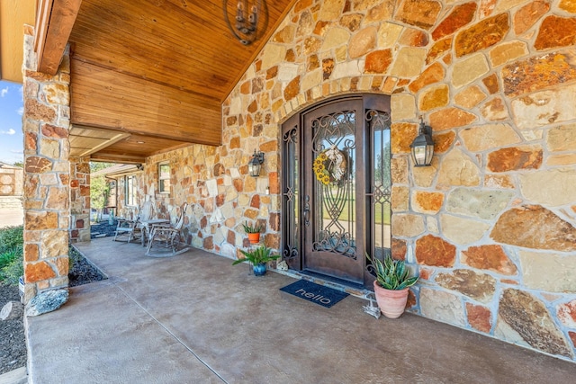 doorway to property with stone siding