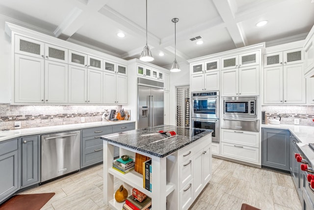 kitchen featuring gray cabinetry, built in appliances, hanging light fixtures, a warming drawer, and open shelves