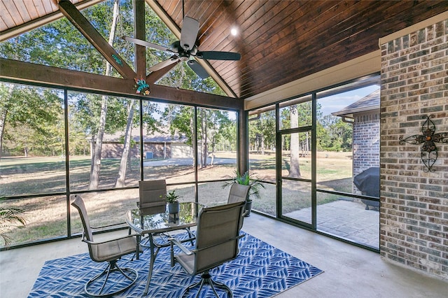 sunroom / solarium featuring lofted ceiling, wood ceiling, and a ceiling fan