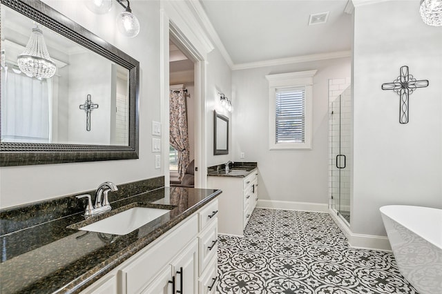 full bath with visible vents, a shower stall, crown molding, baseboards, and a sink