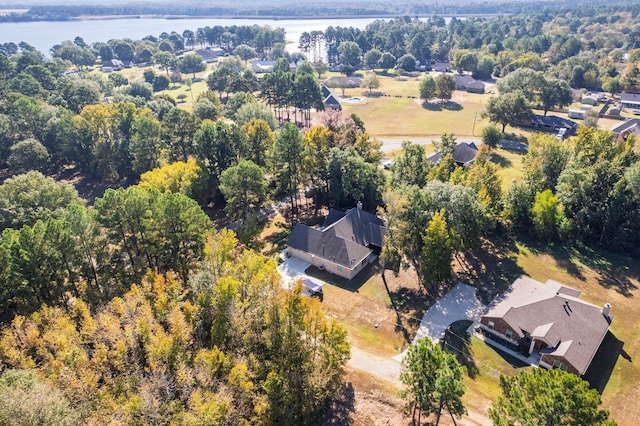 aerial view with a forest view and a water view