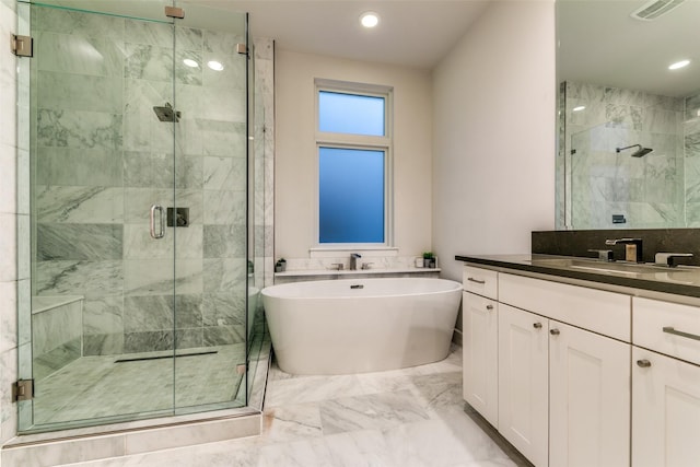 full bathroom featuring vanity, visible vents, a stall shower, a freestanding bath, and marble finish floor